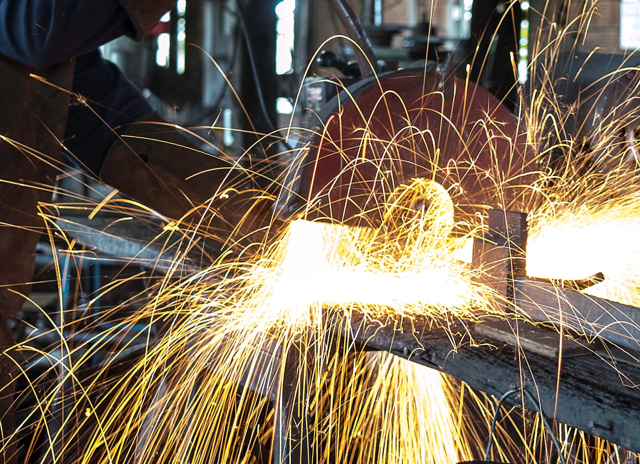 Vibrant sparks fly during welding in a busy workshop, showcasing intense craftsmanship.